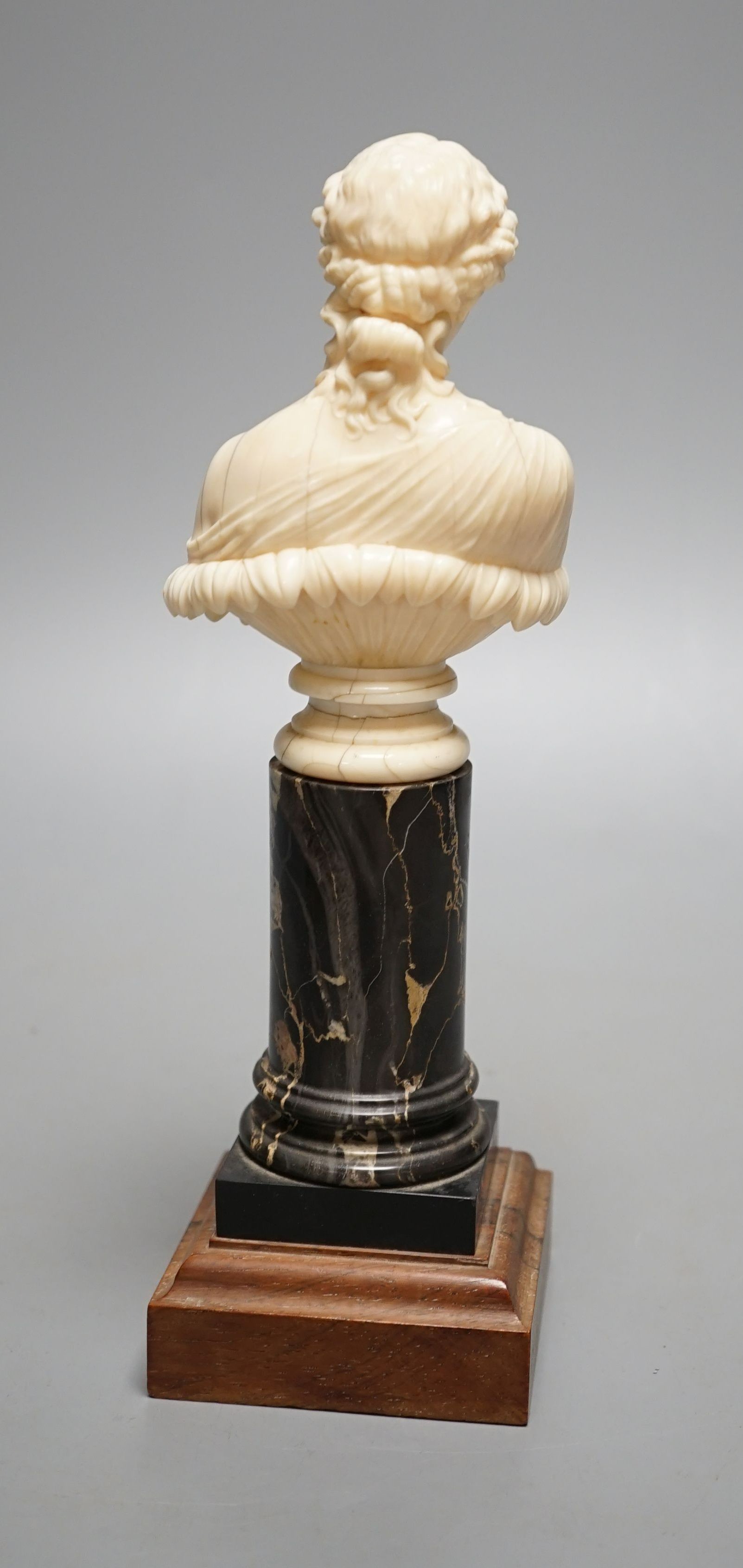 A 19th-century Dieppe ivory bust of Clytie, on a marble and rosewood pedestal, after the model in the British Museum - 24.5cm tall